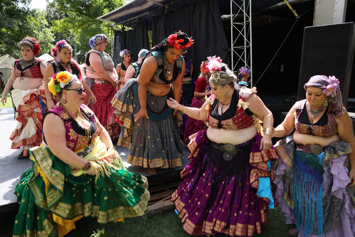 Akashic Moves Belly Dancers help each other down from the stage after performing at the Hyde Park Street Fair in Boise, Idaho, on Sept 18. This was the first time the Hyde Park Street Fair had been held since the pandemic.   