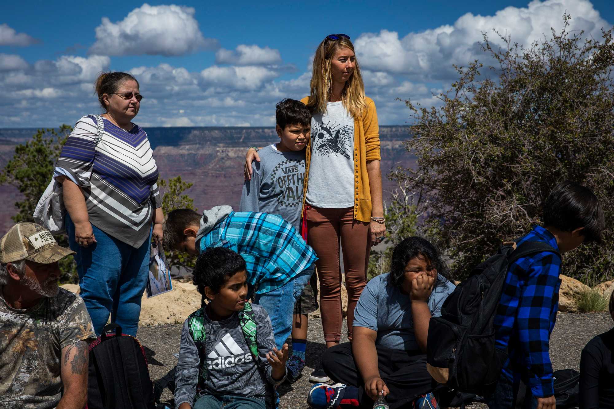 Carolyn Harmon put her arms around one of her fourth-grade students while holding class along the rim of the Grand Canyon. Harmon is a teacher at the Grand Canyon Unified School District, the only school district located inside a national park. 