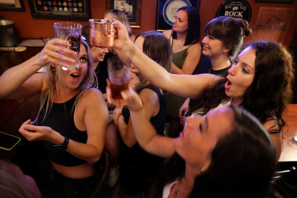Bride-to-be Megan Sutterer (right) shared a toast with friends during her bachelorette party at The Ohio Club.