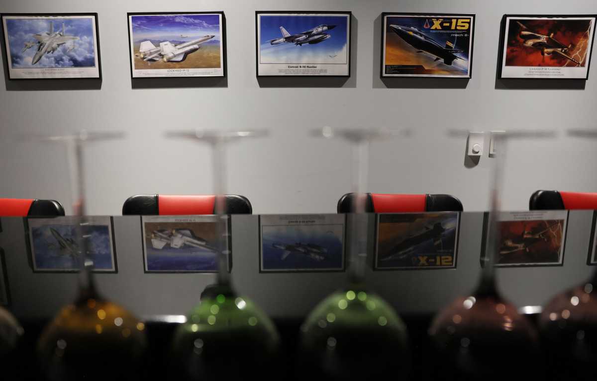 Framed photos of fighter jets lined the walls of the bar inside the Survival Condo.   