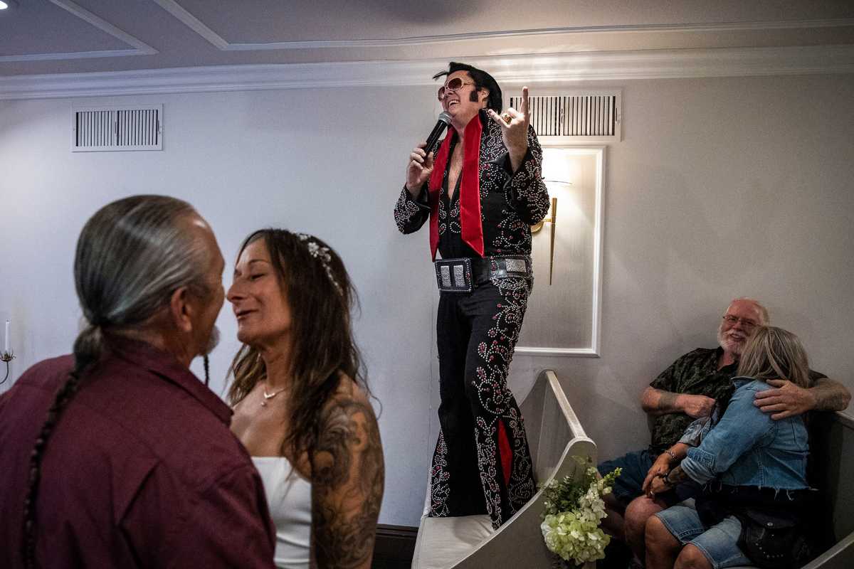 James and Cindy Richardson (left) of Stoughton, Mass., shared a moment after Brendan Paul (center) married them at the Graceland Wedding Chapel in Las Vegas. The Richardsons traveled to Vegas for the wedding with their friends Dick MacKerer and Lisa Walsh (right) from Avon, Mass. 