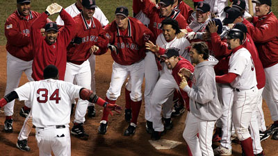 David Ortiz celebrates with teammates as he crosses home plate after his 12-inning walkoff home run against the Yankees in teh 2004 ALCS.