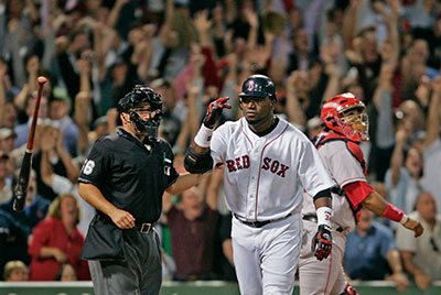 David Ortiz flips away his bat in triumph after hitting a walkoff home run against the Angels on Sept. 6, 2005. Angels catcher Jose Molina and home plate umpire Eric Cooper watch the flight.