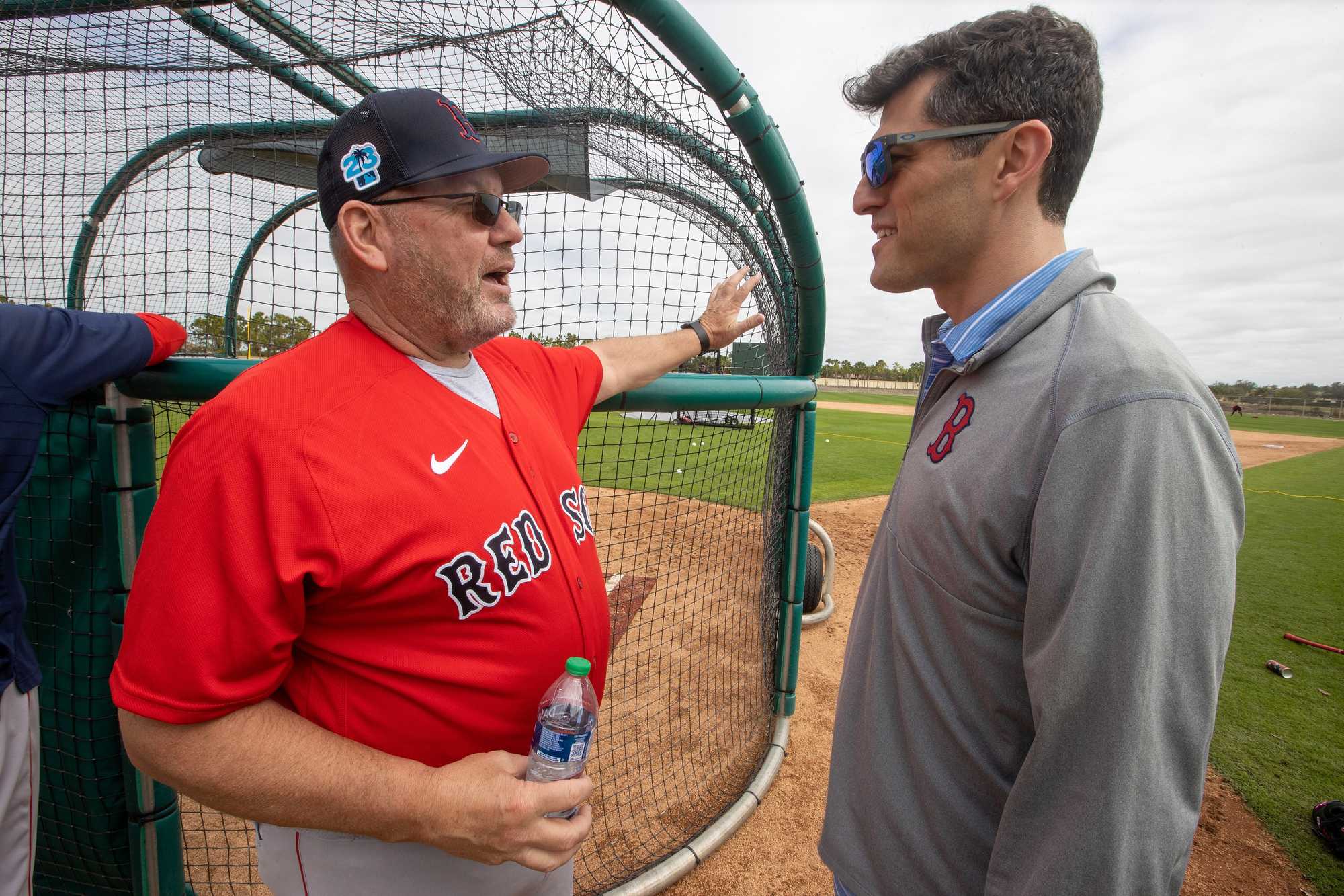 Chaim Bloom (right) chatted with minor league coach Rich Gedman during spring training. The Red Sox have worked to shore up resources within their coaching and development ranks to better compete with top teams.